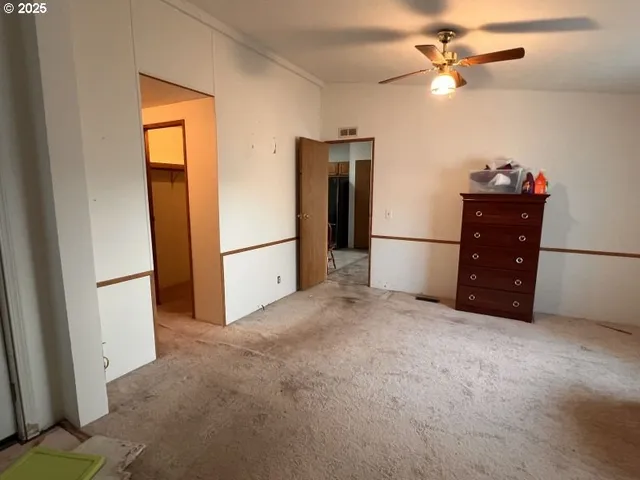 a view of a hallway with wooden floor and stairs