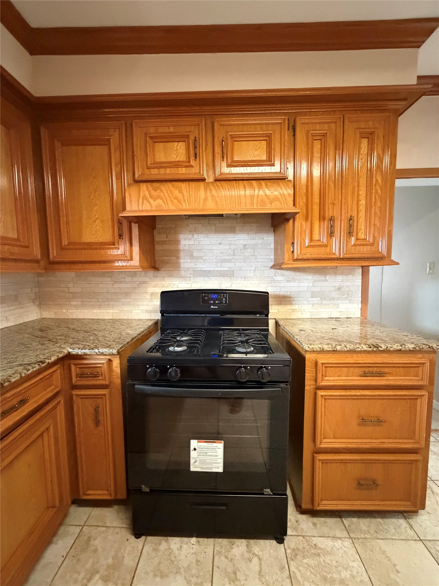 703 76th Street Houston, TX 77012 - Photo 11 of 23 a stove top oven sitting inside of a kitchen