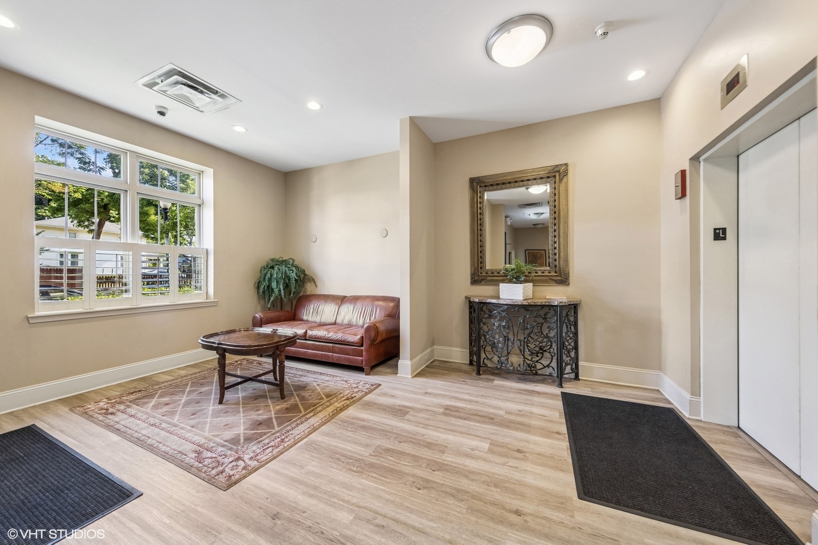 965 Rogers Street, Unit 202 Downers Grove, IL 60515 - Photo 14 of 15 a living room with furniture and a table