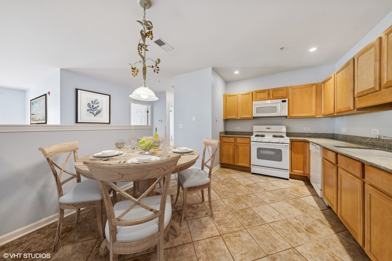 965 Rogers Street, Unit 202 Downers Grove, IL 60515 - Photo 6 of 15 a kitchen with stainless steel appliances a table and chairs in it