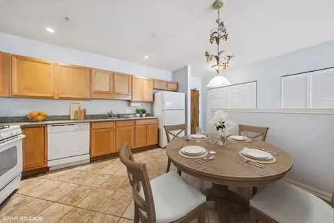 a kitchen with a sink dining table and chairs