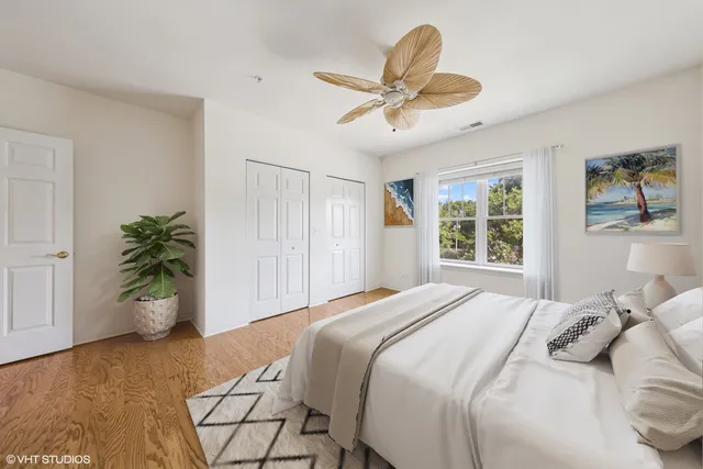a bedroom with a bed and a potted plant