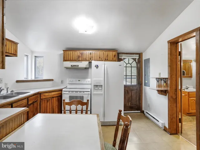 a kitchen with stainless steel appliances a refrigerator and a stove top oven