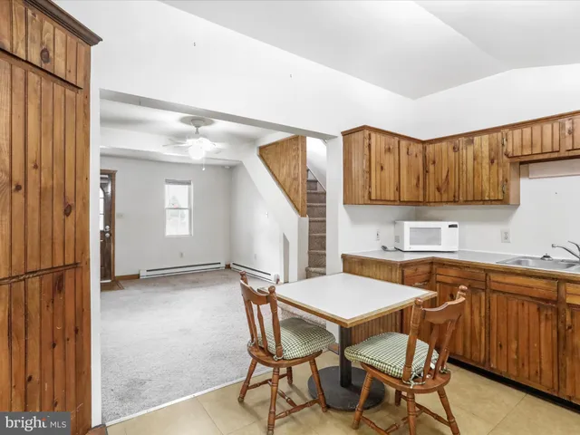 a kitchen with a table chairs and a refrigerator