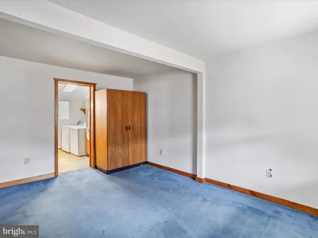 an empty room with closet area