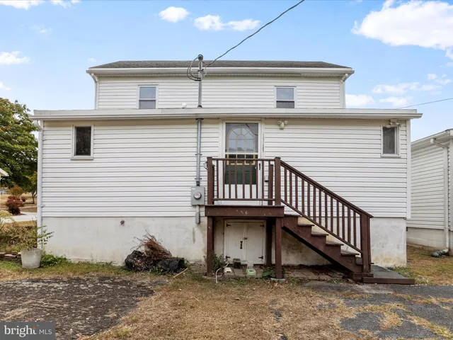 a view of a house with wooden fence