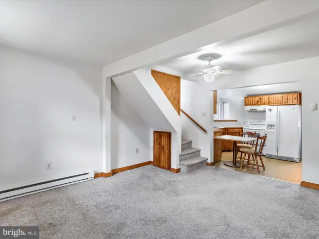 a view of a livingroom with furniture and a window