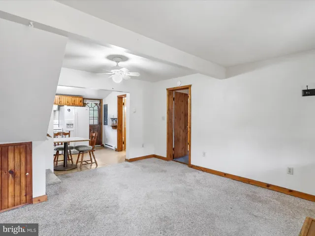 an empty room with furniture and white walls