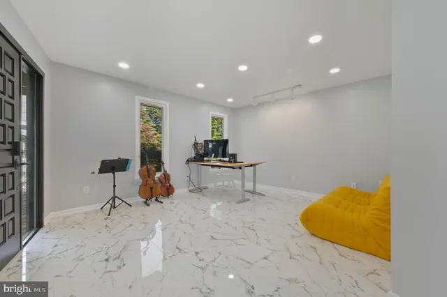 a spacious bedroom with a bed a couch and dresser