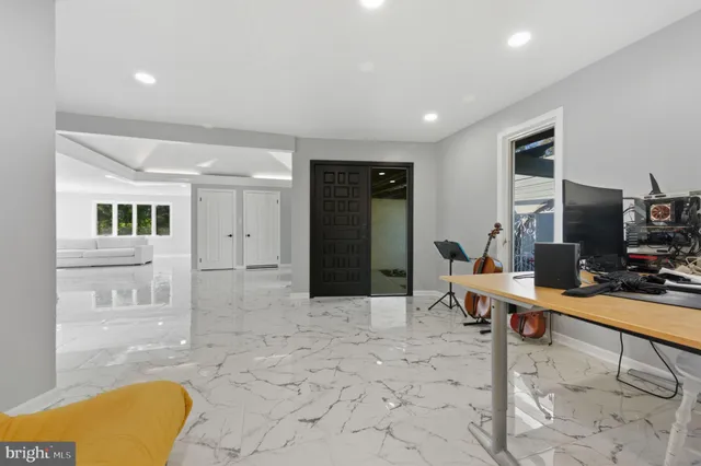 a spacious bathroom with a tub and large windows