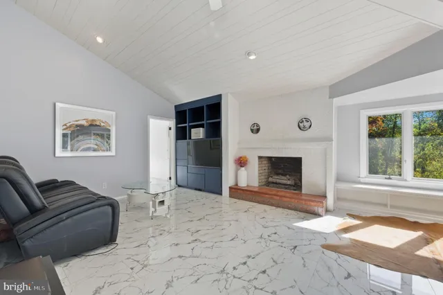 a view of an empty room with a fireplace and a large window