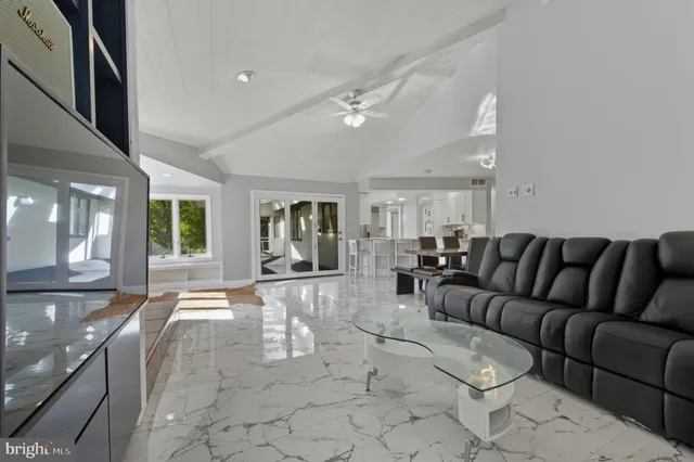 a view of an empty room with a fireplace and a window