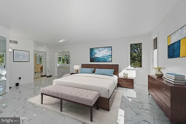 a bedroom with a large bed and a couch