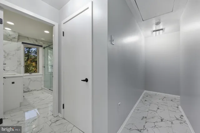 a view of a house with a yard and large trees