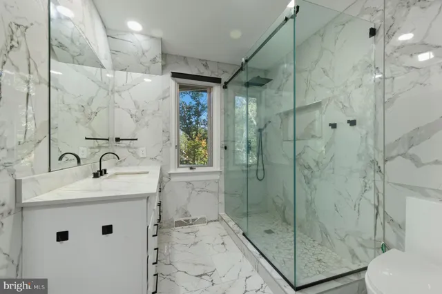 an aerial view of a house with a yard and lake view