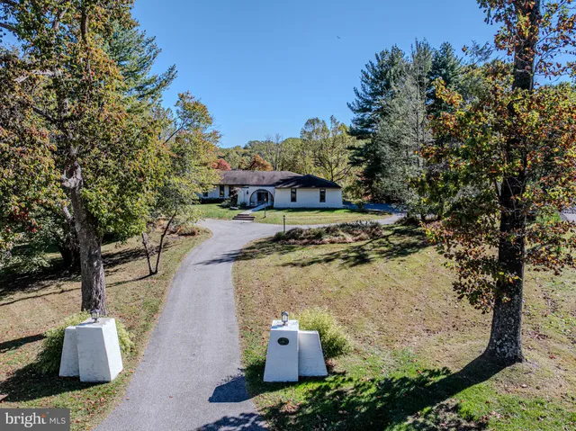 a bathroom with a granite countertop sink a mirror and shower