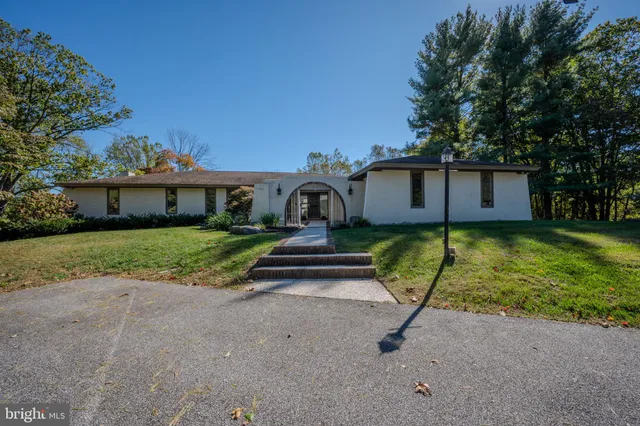 a kitchen that has a lot of cabinets in it and wooden floors
