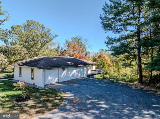a kitchen with granite countertop a sink and a refrigerator