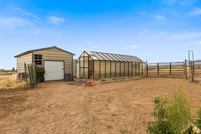 2925 Juniper Road Enterprise, UT 84725 - Photo 38 of 56 View of yard with an outbuilding and a greenhouse