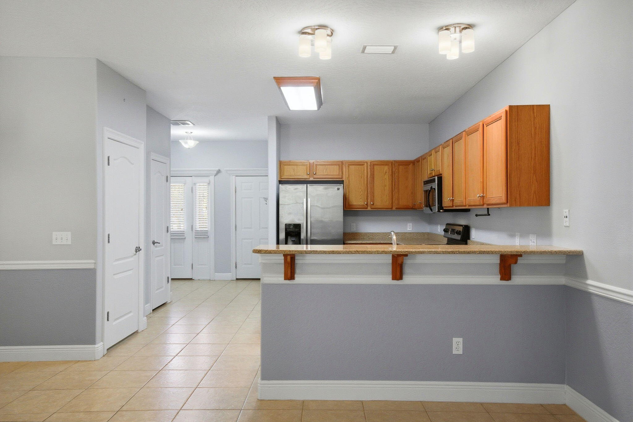 8562 Laredo Street Navarre, FL 32566 - Photo 12 of 43 a kitchen with counter top space and appliances