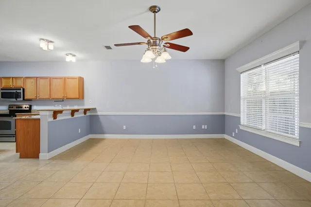 a kitchen with a refrigerator a stove a microwave and cabinets