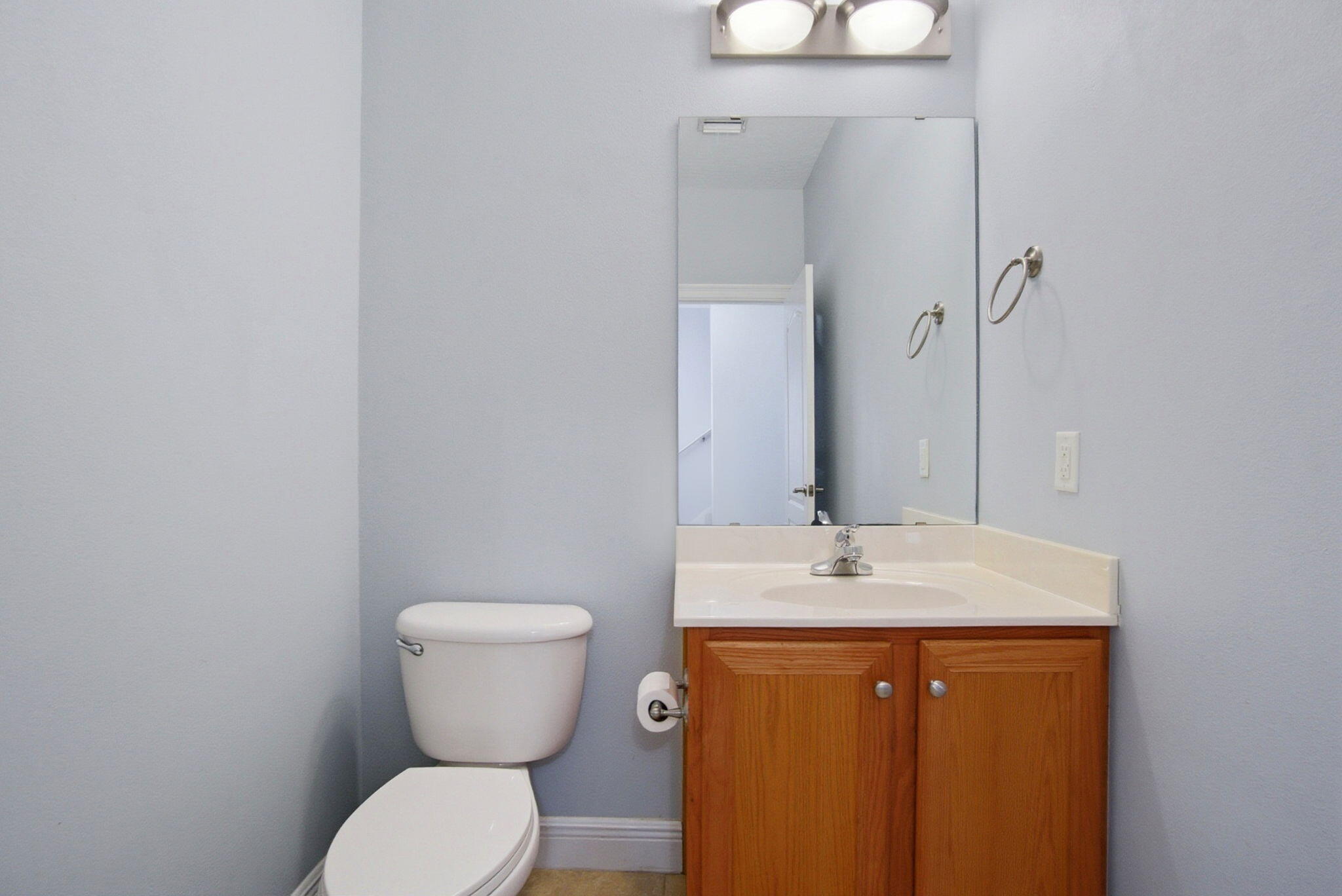 8562 Laredo Street Navarre, FL 32566 - Photo 19 of 43 a bathroom with a granite countertop toilet sink and mirror
