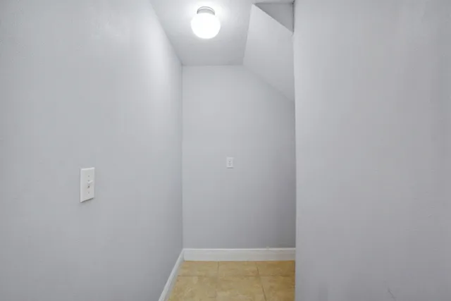 an empty room with a window and a ceiling fan