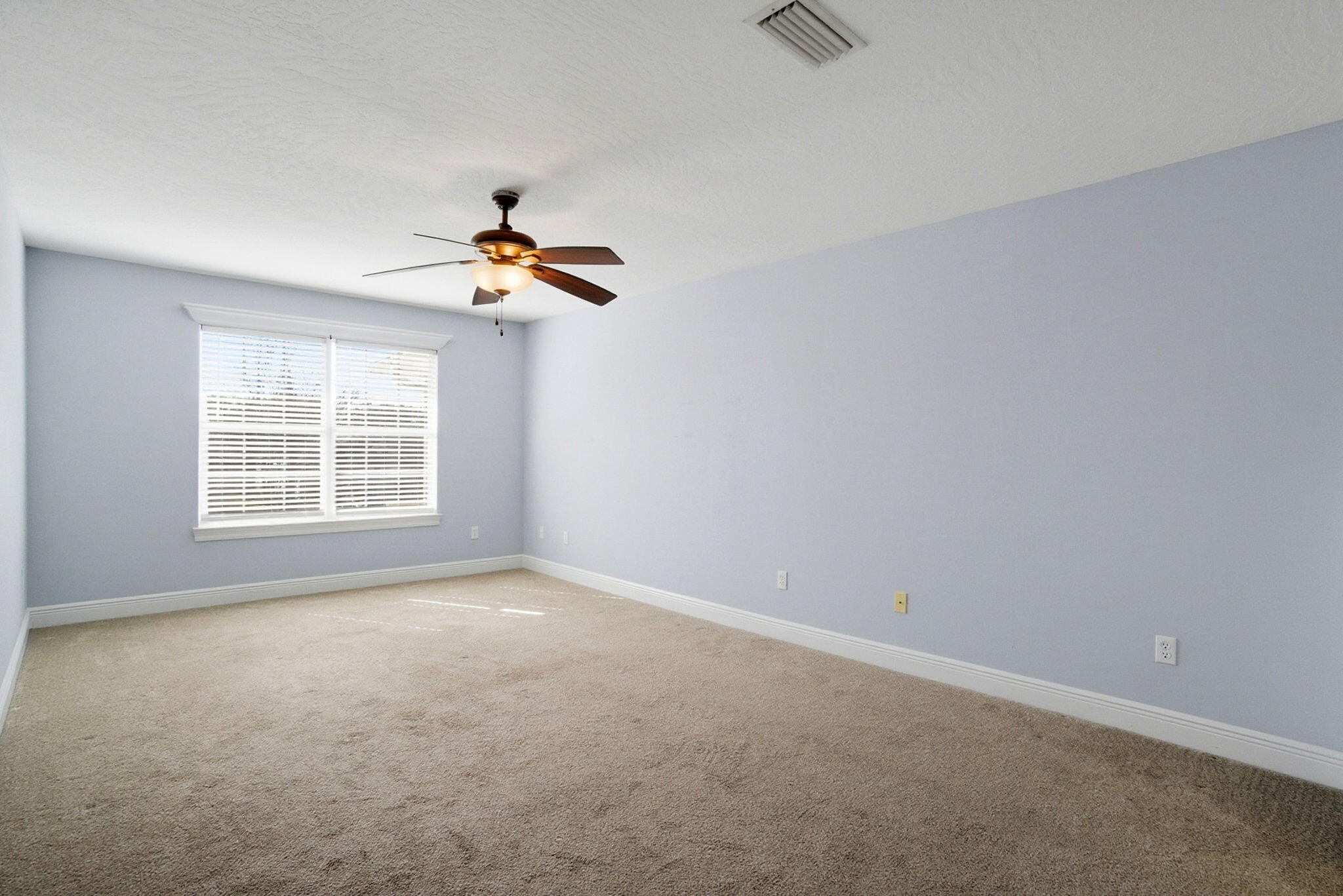 8562 Laredo Street Navarre, FL 32566 - Photo 21 of 43 an empty room with a window and a ceiling fan