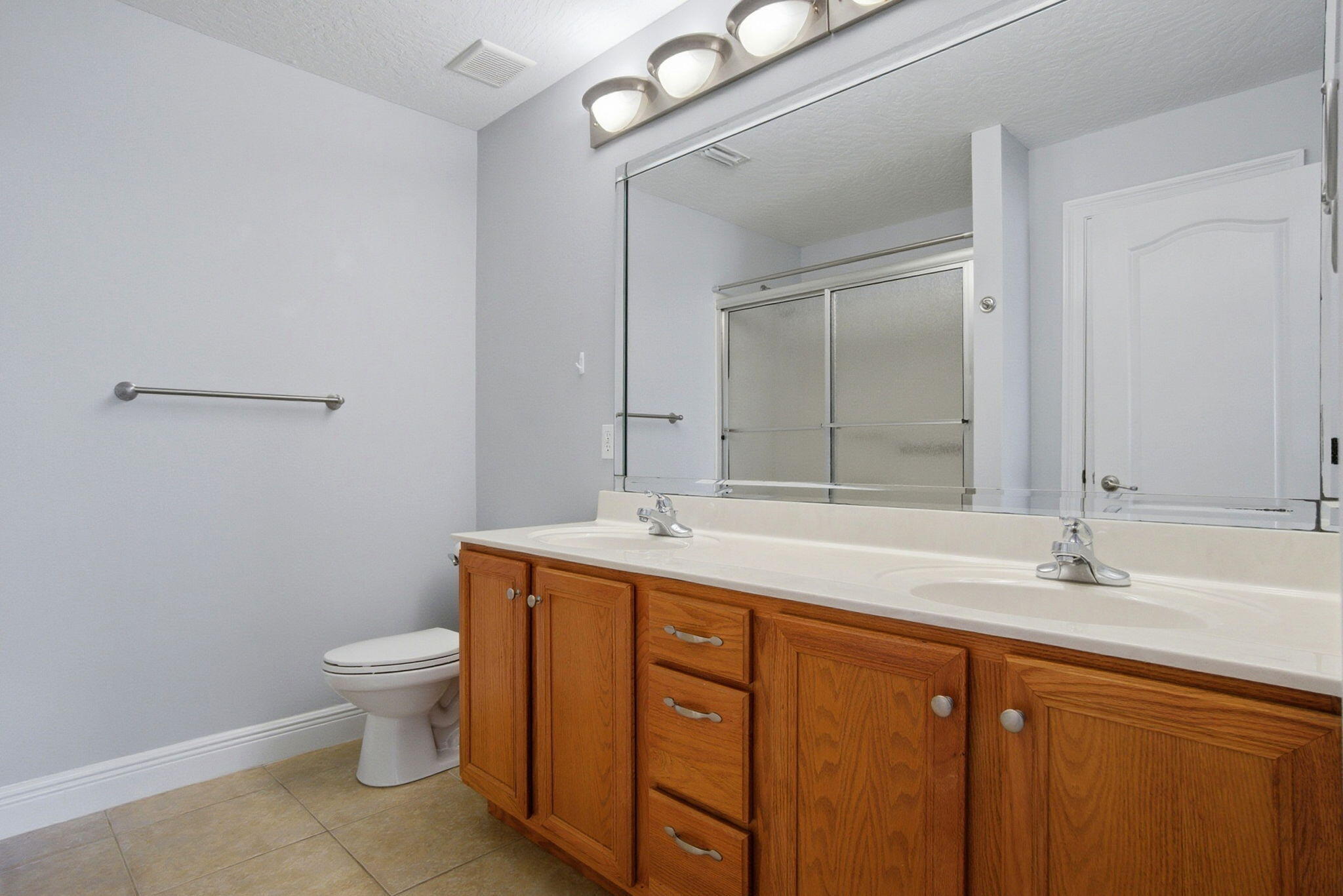 8562 Laredo Street Navarre, FL 32566 - Photo 24 of 43 a bathroom with a granite countertop sink a toilet and a mirror