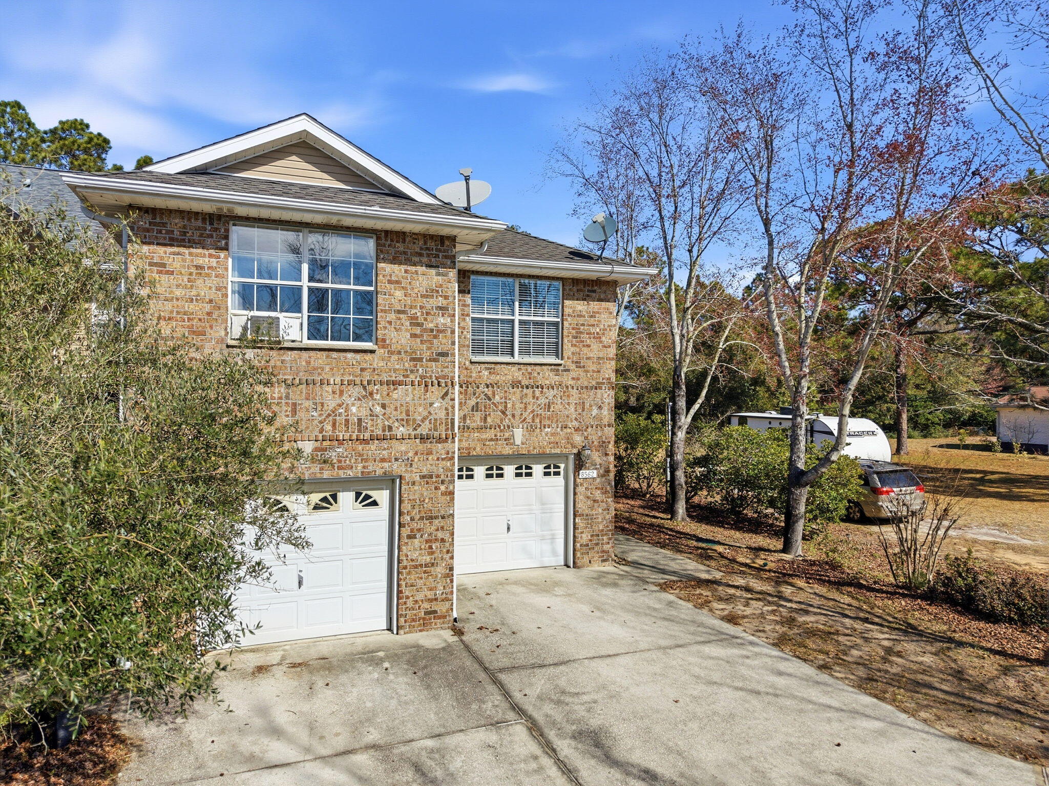8562 Laredo Street Navarre, FL 32566 - Photo 3 of 43 a front view of a house with a yard