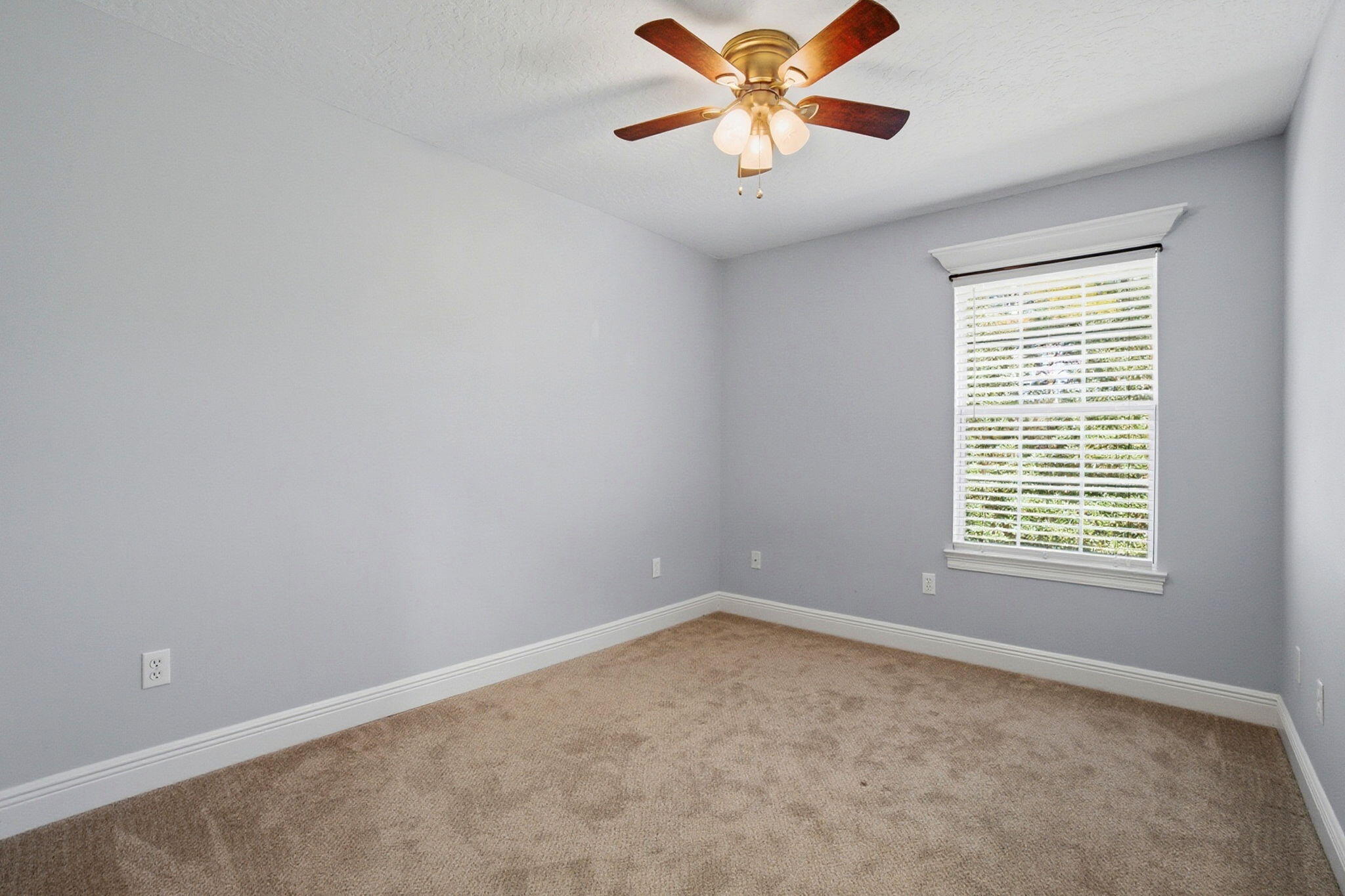 8562 Laredo Street Navarre, FL 32566 - Photo 31 of 43 an empty room with a window and a fan