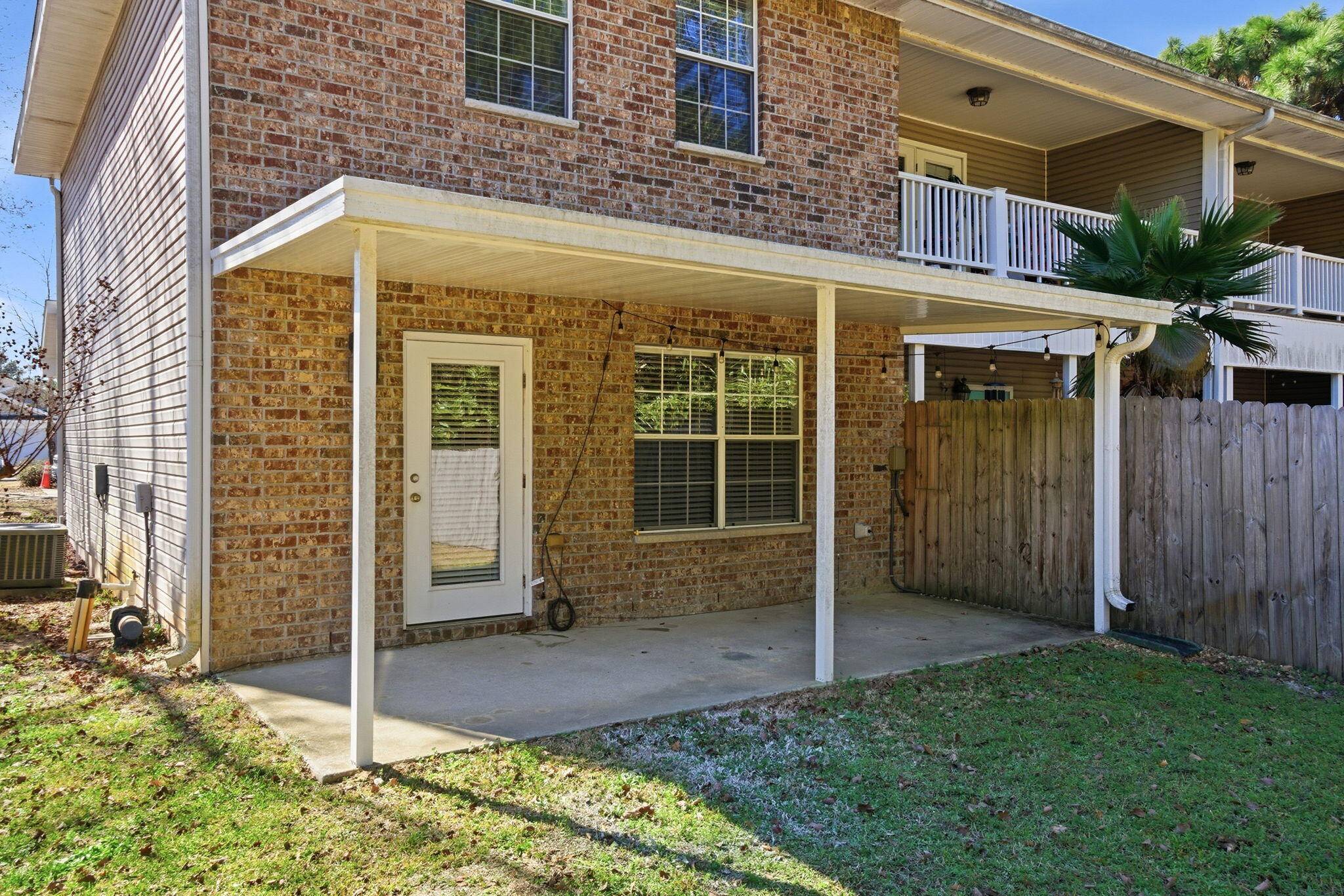 8562 Laredo Street Navarre, FL 32566 - Photo 38 of 43 a view of a brick house with a large door