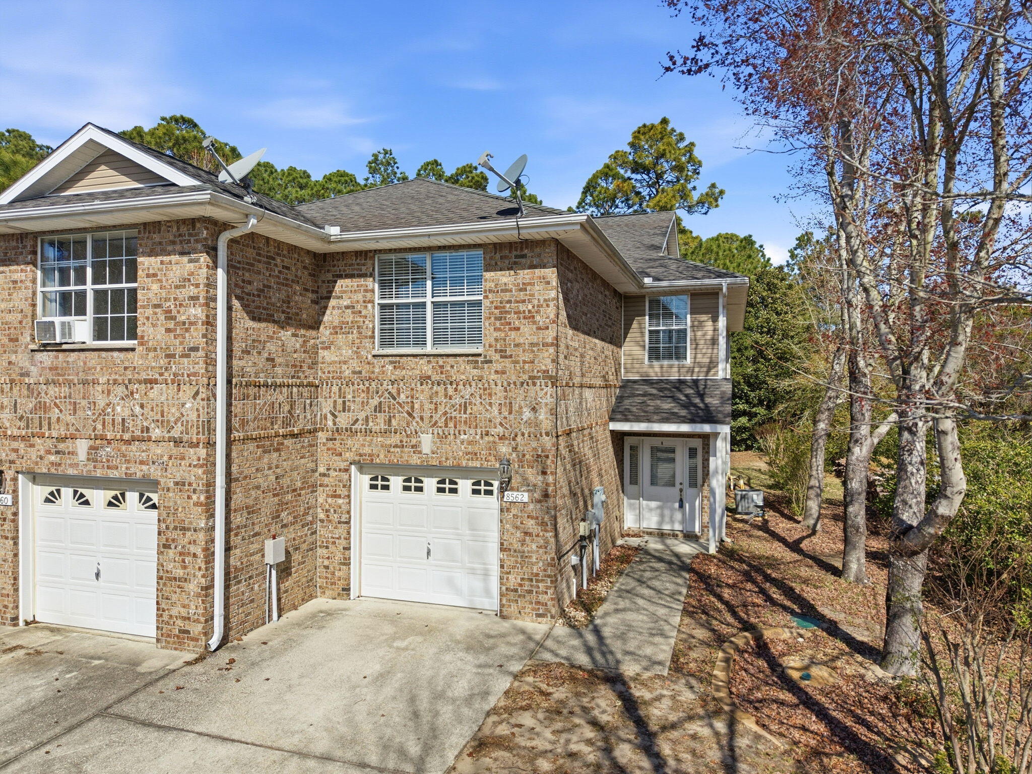 8562 Laredo Street Navarre, FL 32566 - Photo 4 of 43 a front view of a house with a garden