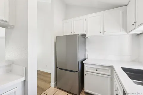a white refrigerator freezer and a stove sitting inside of a kitchen