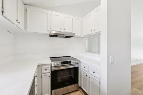 a kitchen with appliances a sink and cabinets