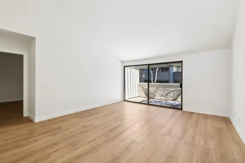 a view of a room with wooden floor and fence