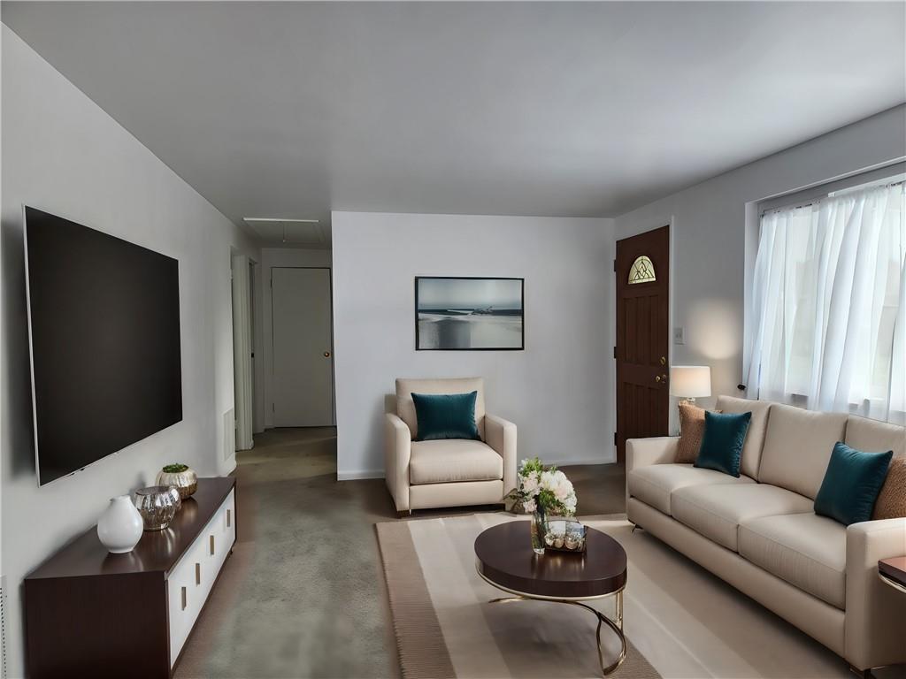 9 South Spring Street Pittsburgh, PA 15223 - Photo 2 of 22 a living room with furniture and a flat screen tv