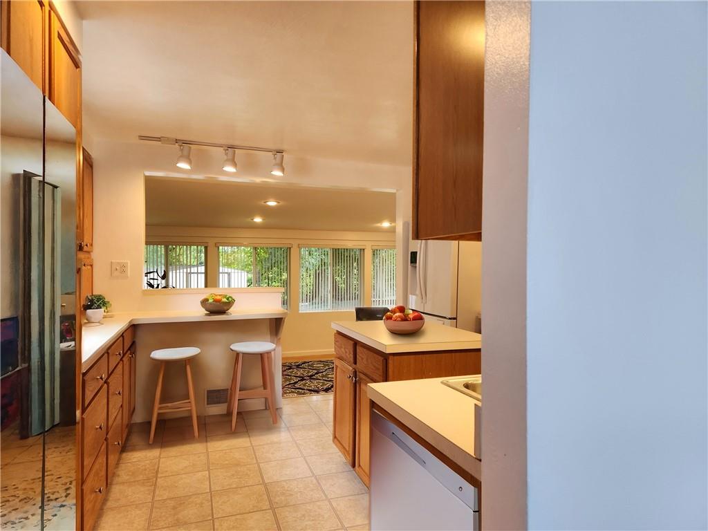 9 South Spring Street Pittsburgh, PA 15223 - Photo 5 of 22 a kitchen with a sink and chairs