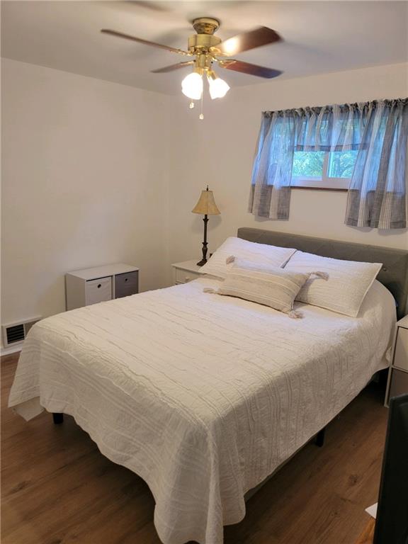 9 South Spring Street Pittsburgh, PA 15223 - Photo 8 of 22 a bedroom with a bed and a chandelier