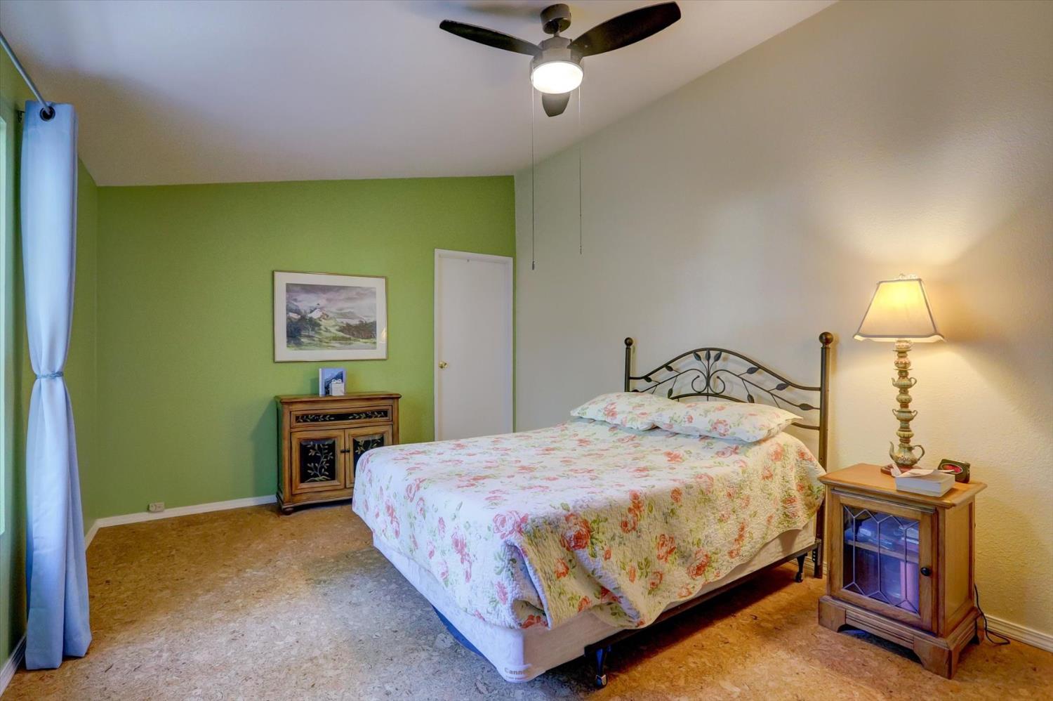 251 Willow Valley Road, Unit 17 Nevada City, CA 95959 - Photo 13 of 58 a bedroom with a bed table and chair