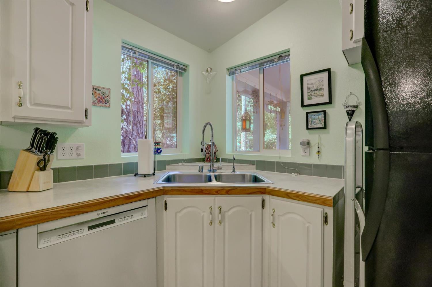 251 Willow Valley Road, Unit 17 Nevada City, CA 95959 - Photo 18 of 58 a kitchen with a sink and a refrigerator