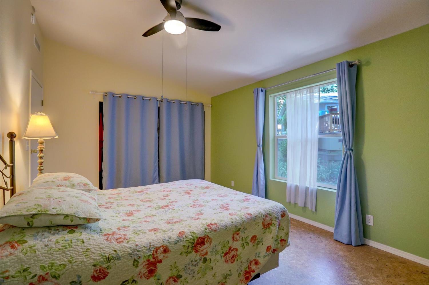 251 Willow Valley Road, Unit 17 Nevada City, CA 95959 - Photo 22 of 58 a bedroom with a large bed and a chandelier