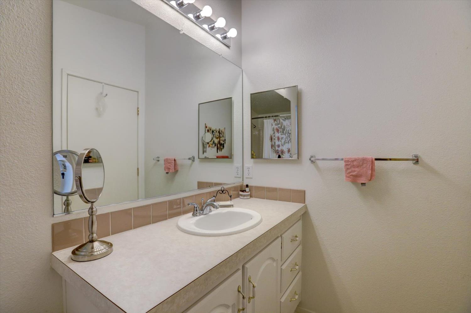 251 Willow Valley Road, Unit 17 Nevada City, CA 95959 - Photo 24 of 58 a bathroom with a sink vanity and a mirror