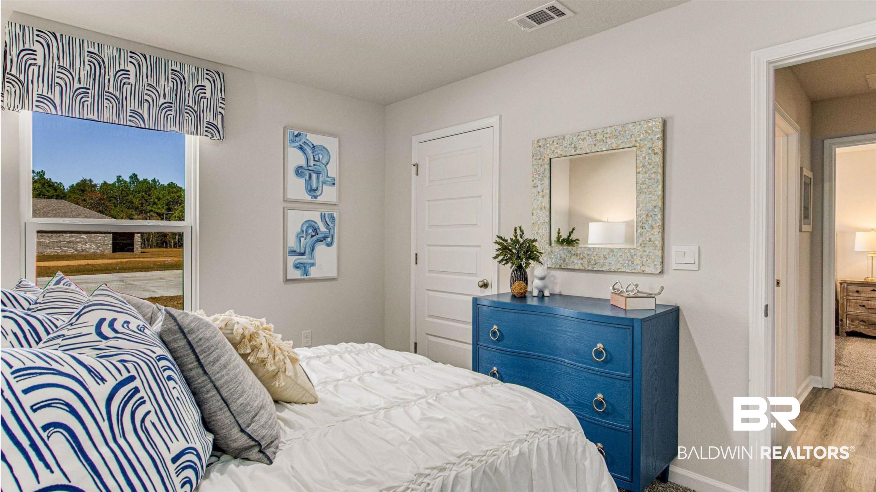 1040 Hayward Loop Foley, AL 36535 - Photo 15 of 35 Bright bedroom featuring a large window, neutral wall paint, white trim, and a five-panel interior door