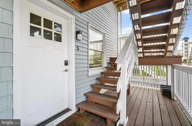 a view of a balcony with wooden floor and fence