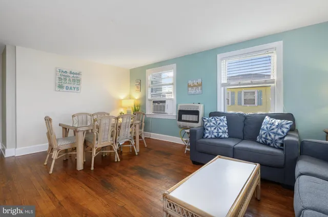 a living room with furniture wooden floor and dining table
