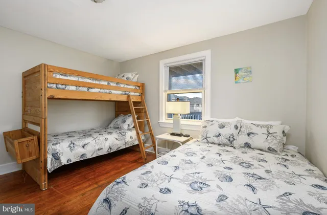 a bedroom with two beds and a window