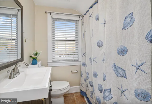 a bedroom with a large bed and a wooden floor