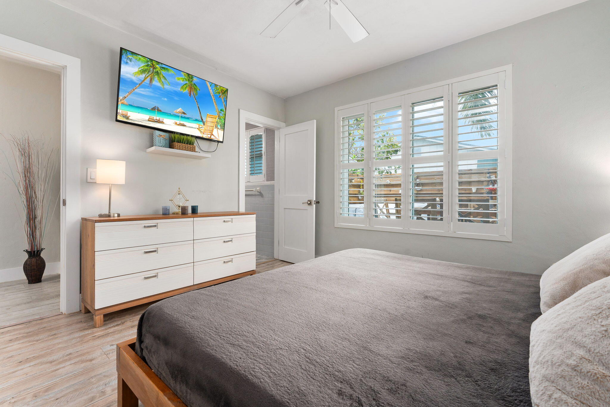 819 Southeast Stypmann Boulevard Stuart, FL 34994 - Photo 12 of 31 a bedroom with a bed and a window