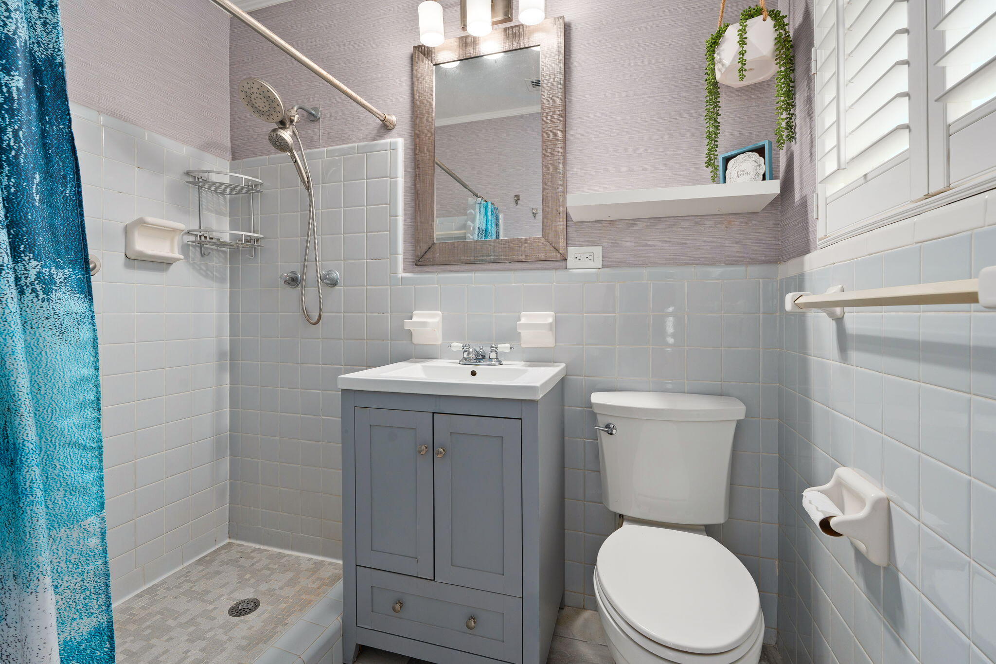 819 Southeast Stypmann Boulevard Stuart, FL 34994 - Photo 13 of 31 a bathroom with a toilet a sink and a shower